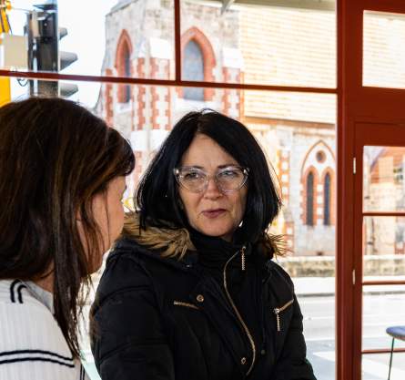 A famil tour participant drinking a coffee at a cafe in Fremantle, Western Australia