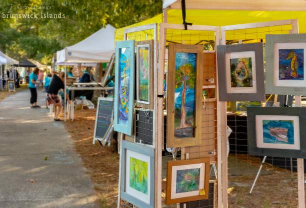 paintings for sale at an outdoor festival