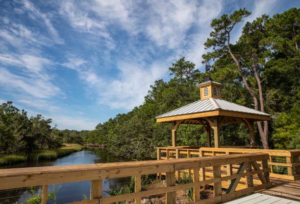 wooden gazebo and walkway overlooking a river