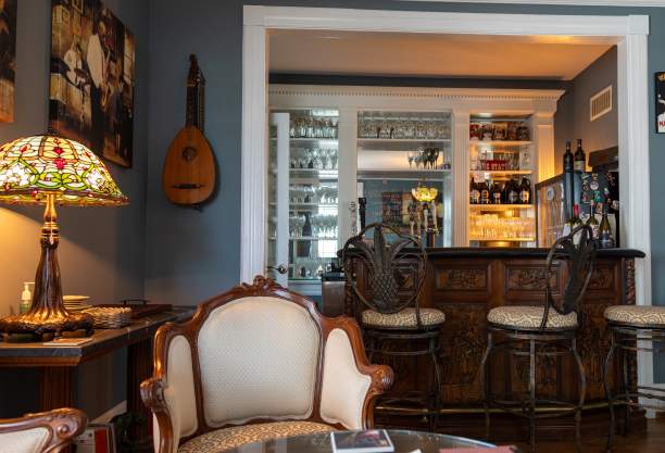 a parlor room with a bar and chairs