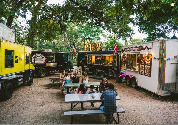 People dining near food trailors at the Rainey Street Food Truck park