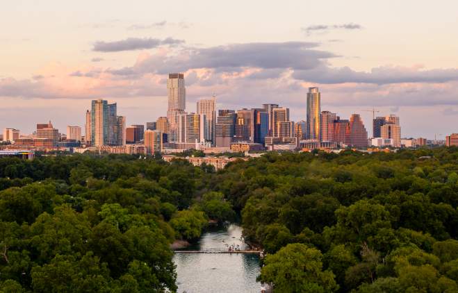 Aerial view of Barton Springs Pool and downtown Austin Texas skyline