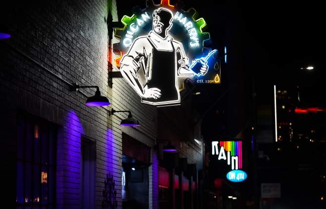 Neon signs in night for Oilcan Harry's and Rain on 4th.