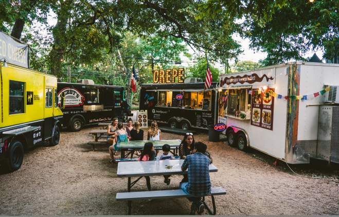 People dining near food trailors at the Rainey Street Food Truck park