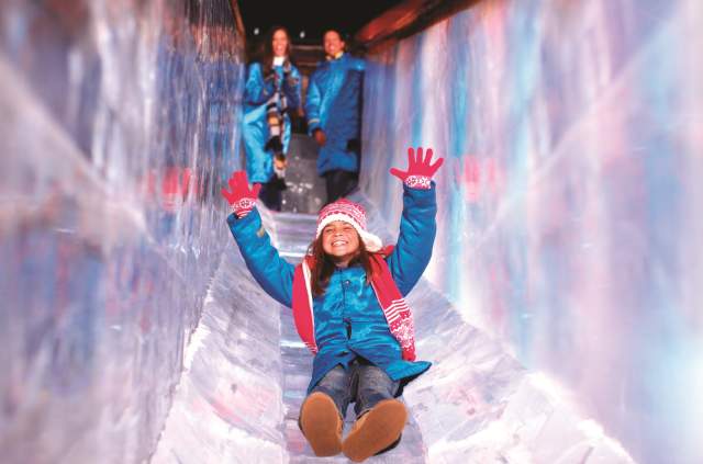 Child enjoying SNOW! slide at Gaylord Texan Resort