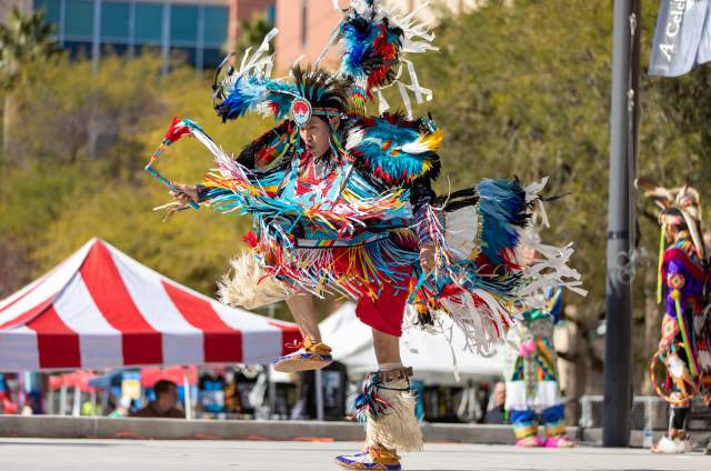 a Native American hoop dancer performance at an outdoor event