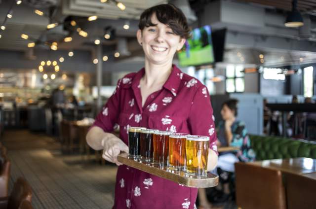 Woman Serving Beer At Hop Social Tavern In Chandler, AZ