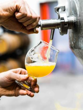 Man pouring a beer out of a tap