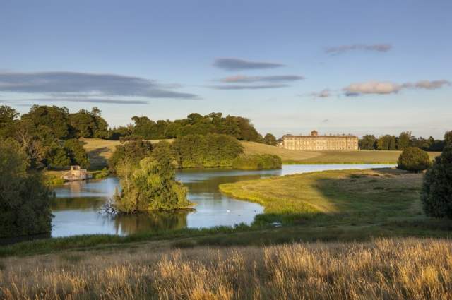 A view across the lake and deer park towards Petworth House in Sussex