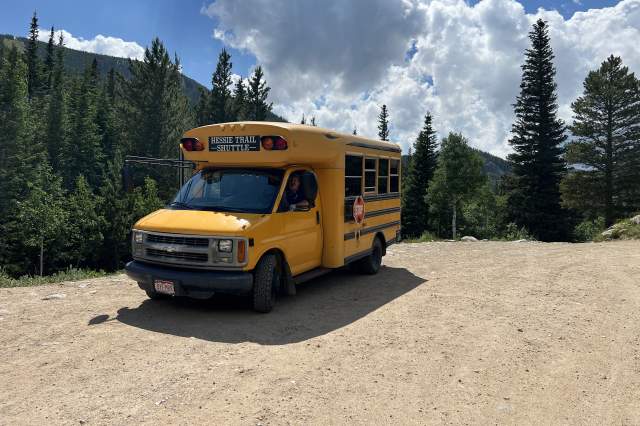 Small yellow school bus parked at Hessie Trailhead