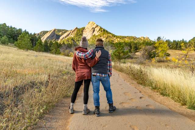Couple at Boulder Flatirons with Arms Around Each Other