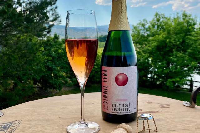 A bottle of Brut Rosé Sparkling with a glass of the same from Vinnie Fera Winery in Boulder, CO