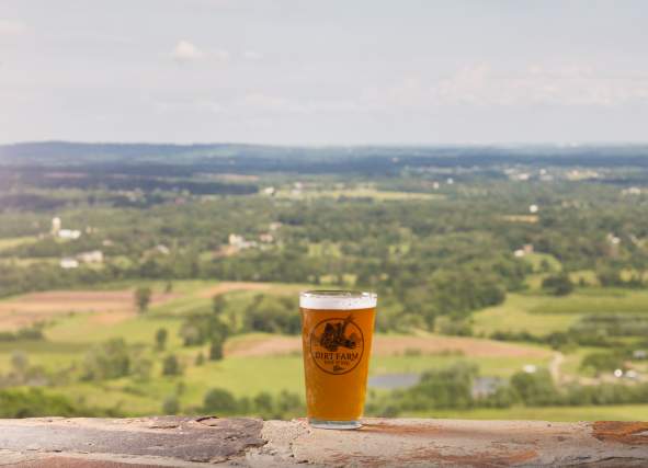 Pint of beer from Dirt Farm overlooking valley.