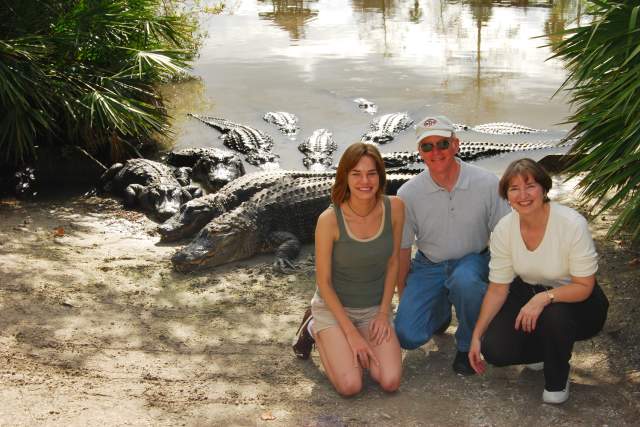 Gatorland family kneeling next to alligators