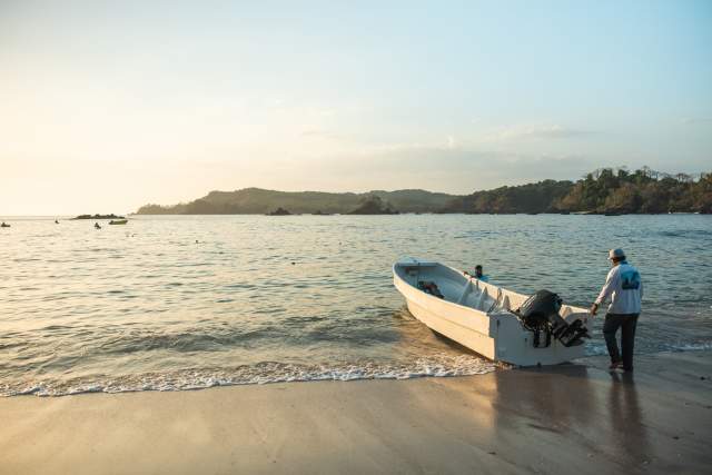 A small fishing boat in the shores of a calm beach at Cerro Hoya