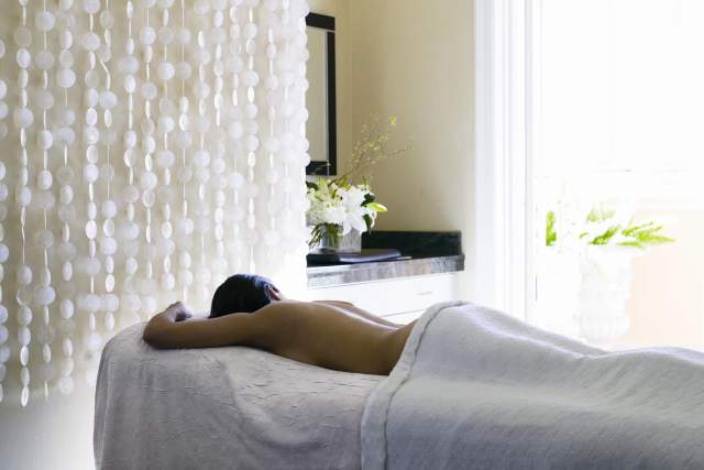 The Ritz-Carlton Spa, Orlando, Grande Lakes woman at the spa getting a massage