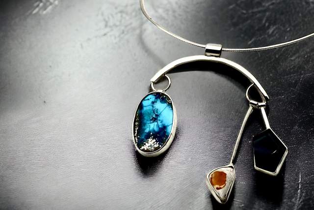 abstract silver earrings have a turquoise and amber stones dangling from the main arched structure