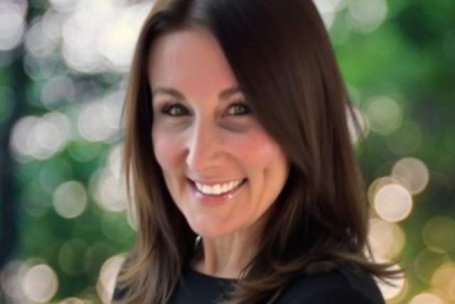 Smiling woman in black dress shirt