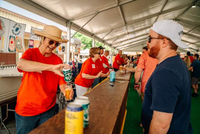 A volunteer pouring a beer at Main Street Fest
