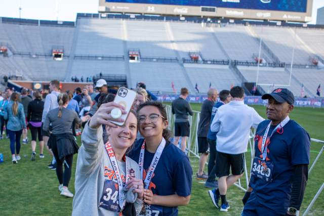 Two young women stop for a selfie after completing the War Eagle Run Fest.