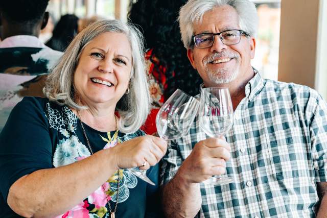 People enjoying a wine-themed special train on the Grapevine Vintage Railroad