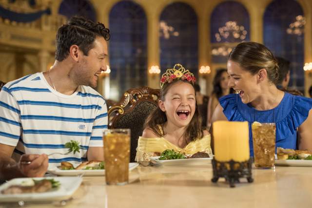 A family at a Be Our Guest dining experience in Magic Kingdom® Park