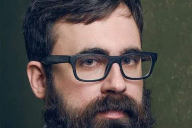 Man with a full beard and glasses
