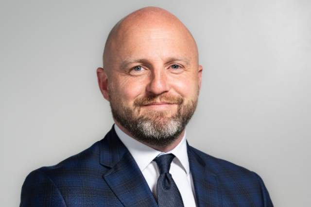 Image of Chris Barney in a suit