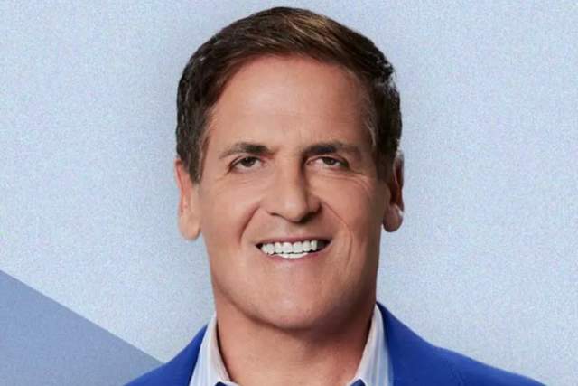 Smiling man in medium blue blazer and blue striped button up shirt