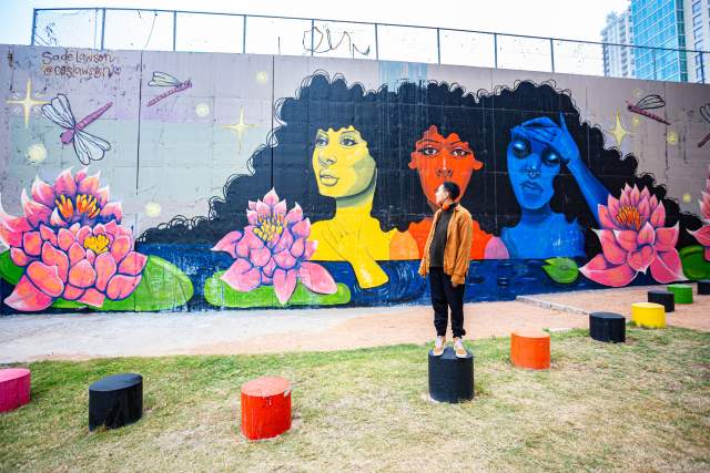 Artist Sade Lawson in front of her mural Its Okay to Not Be Okay