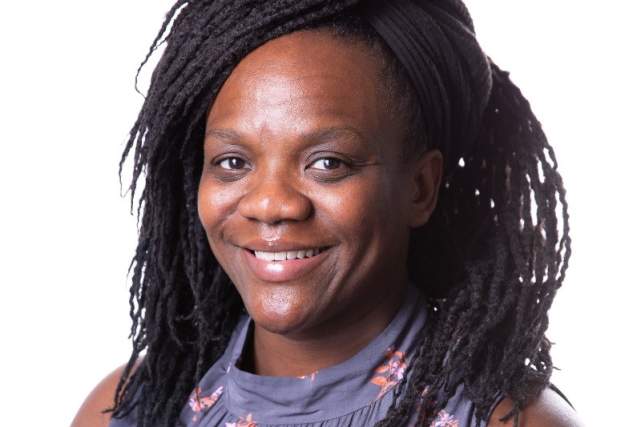 Smiling woman in lavender dress