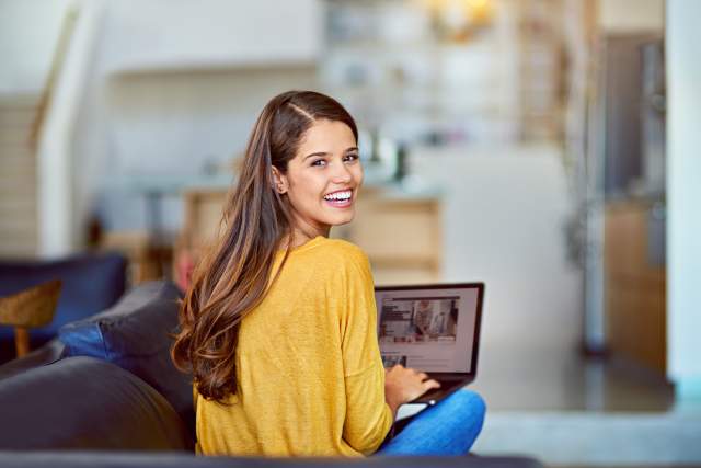 Young woman smiling at a laptop