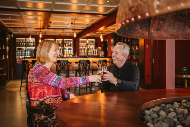 Couple enjoying whisky tasting at Penderyn Distillery Swansea.
