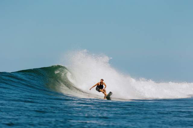 Surfer in Santa Catalina, Panama riding a tubular wave on the Pacific coast.