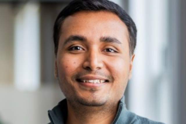 Smiling man medium grey half-zip and white t-shirt