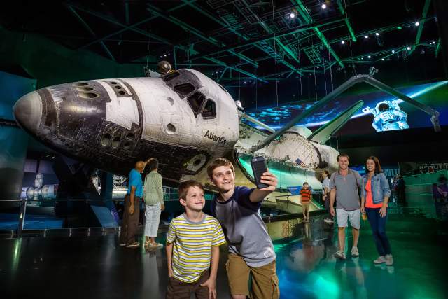Kennedy Space Center Visitor Complex boys taking selfie with space shuttle