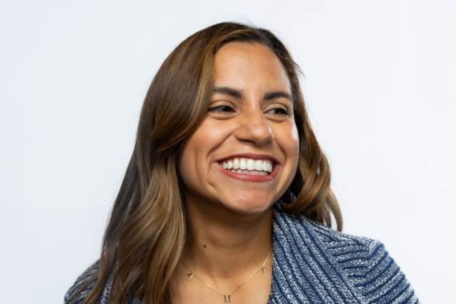 Smiling woman wearing a blue patterned jacket