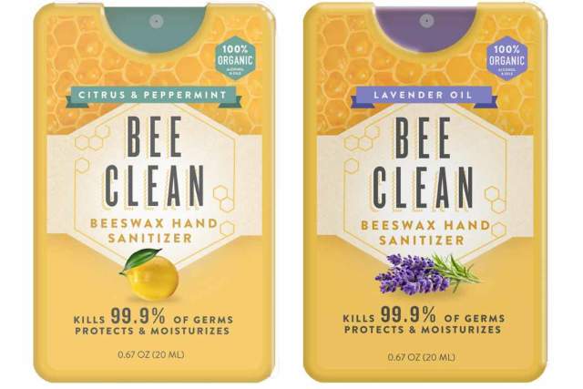 Two yellow tins, one with a lemon and one with lavender sit side by side. Label reads "Bee Clean Beeswax Hand Sanitizer"