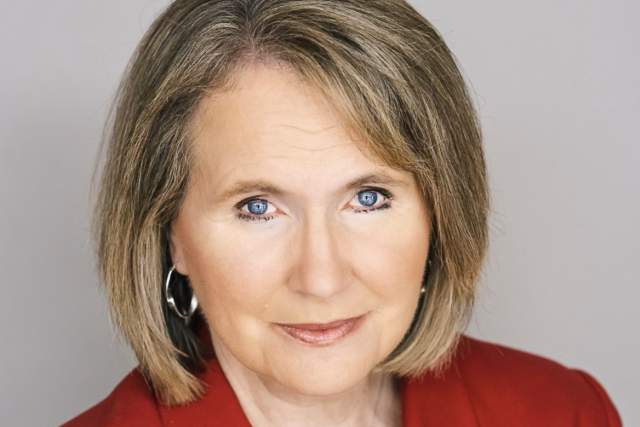 Woman in red suit coat