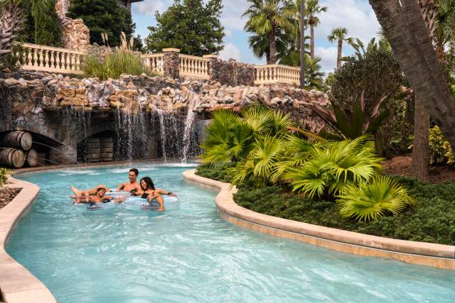 Family floating in the lazy river at the Four Seasons Resort at Walt Disney World Resort