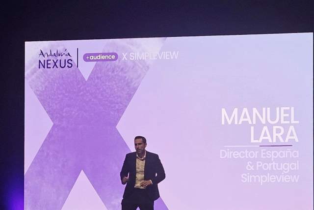 Manuel Lara of Simpleview, now part of Granicus, presenting on stage.