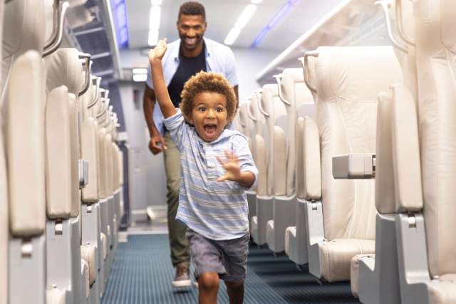 Child in aisle of Brightline train
