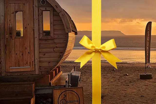 A round sauna shed on a beach.
