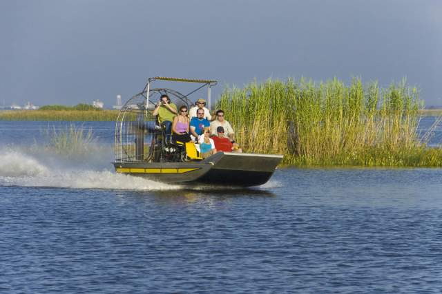 group of people riding on an airboat