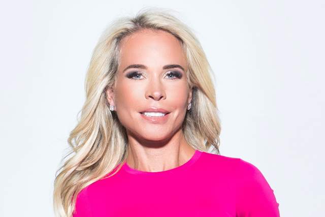 Blond woman in bright pink sweater