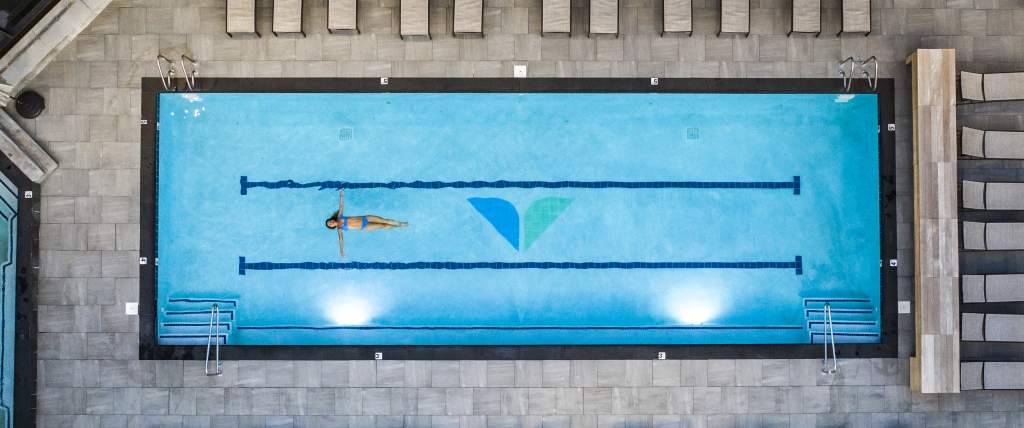 Woman relaxing in pool at Snowbird's Cliff Spa
