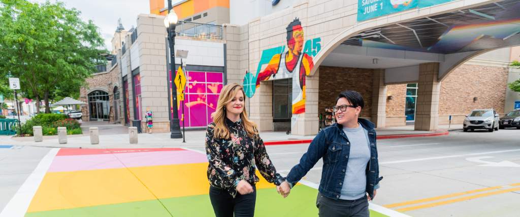 Two women walking holding hand in Salt Lake