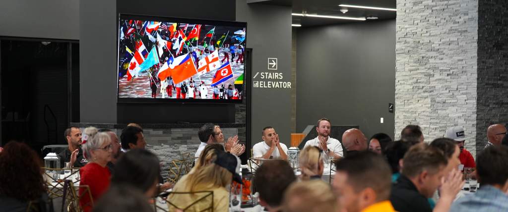 Crowd watching video at Sports Tourism Summit