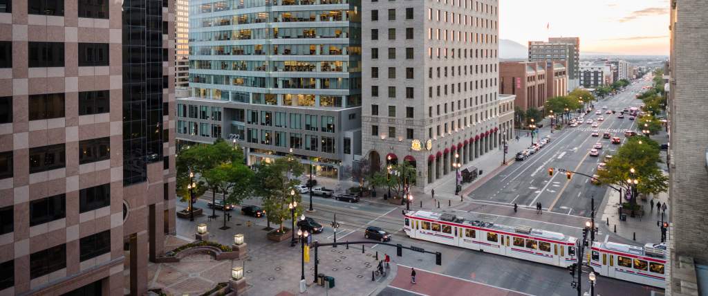 View of Salt Lake City main street with Trax light rail on the street and and early sunset sky