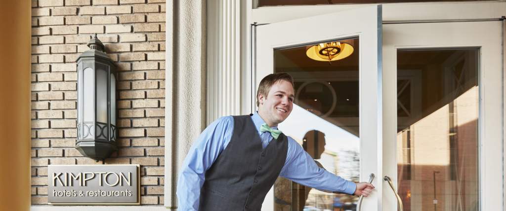 Staff opening the door to a Kimpton hotel